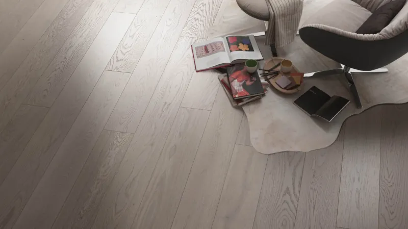 Light oak parquet floor with a rug and magazines
